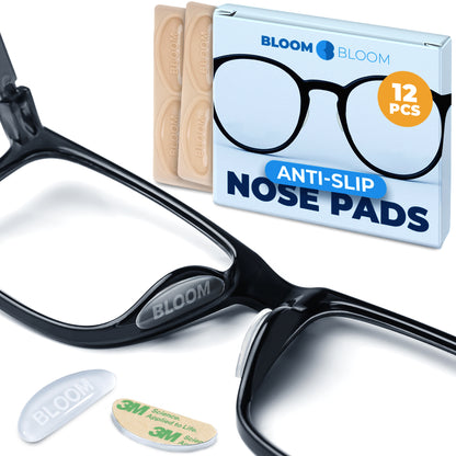 Clear silicone nose pads attached to black plastic eyeglass frame, showing thin profile and smooth edge-free shape on the nose bridge