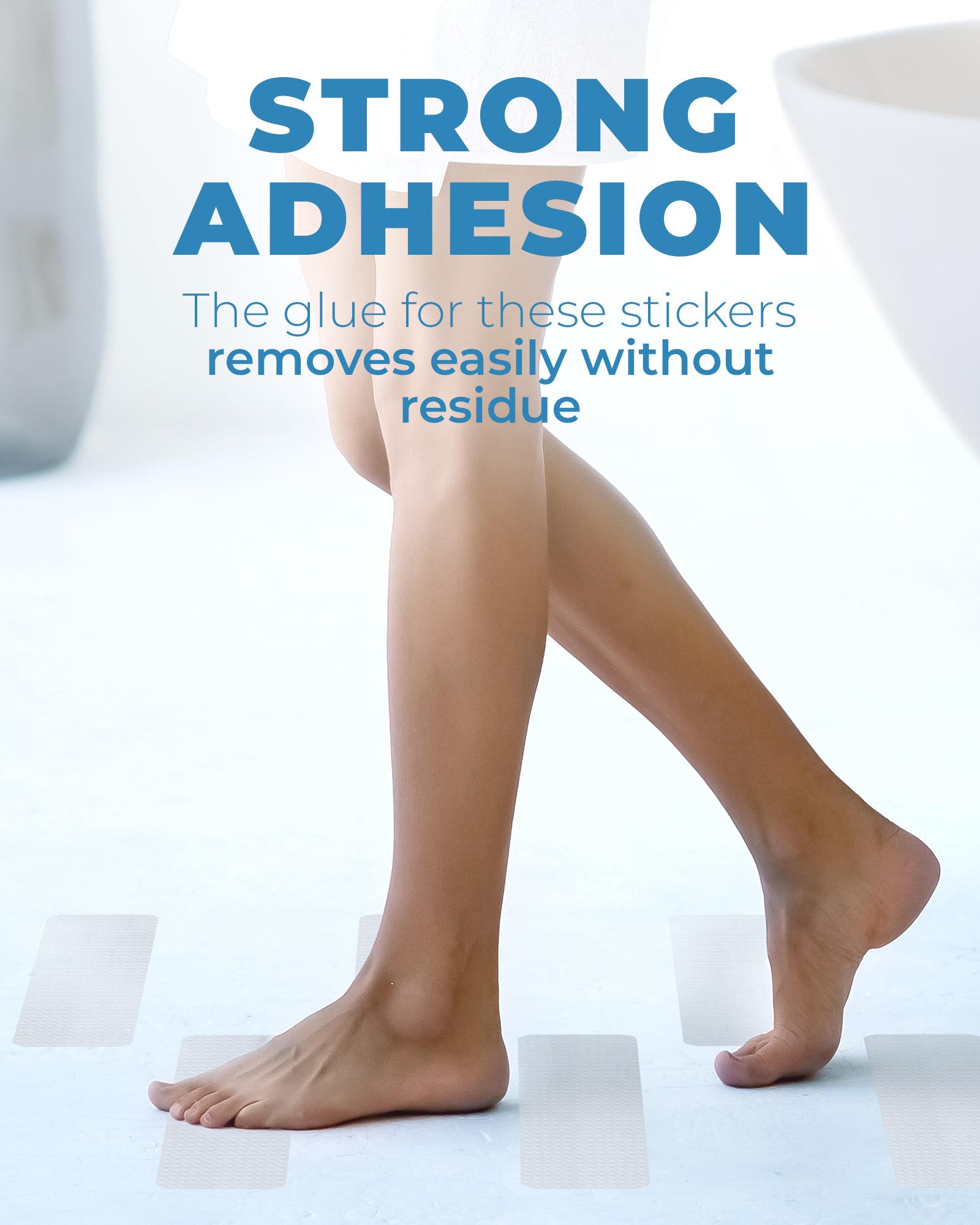 Foot resting on oversized rectangle anti-slip shower stickers inside a bathtub, showing everyday use on smooth surfaces in a home bathroom setting