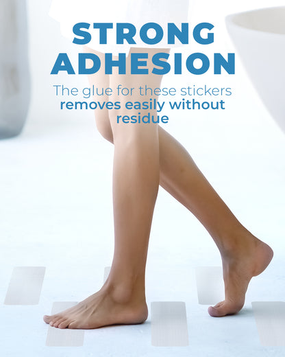 Foot resting on oversized rectangle anti-slip shower stickers inside a bathtub, showing everyday use on smooth surfaces in a home bathroom setting